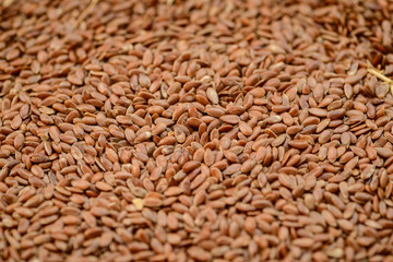Closeup flax seeds as natural background. Selective focus.