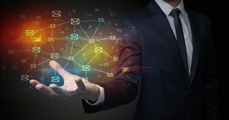 Businessman holding communication symbols