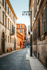 Fototapeta na wymiar Cobbled streets on old stoned street in the beautiful evening sunset in Verona, Italy