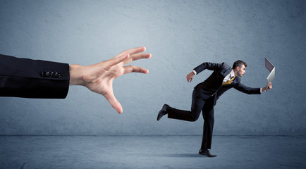 Businessman running from hand