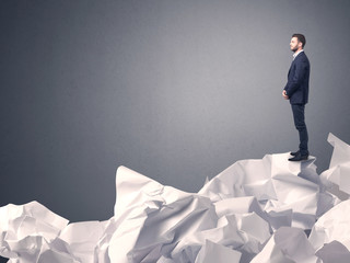 Businessman standing on crumpled paper