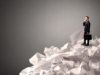 Businessman standing on crumpled paper