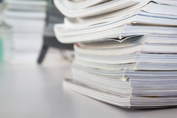 stacked magazine books on white table