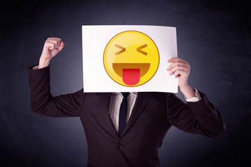 Businessman holding paper with emoticon