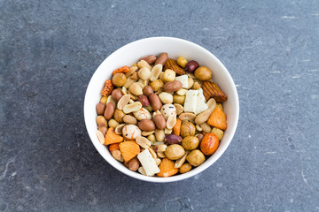 nuts and seeds in a bowl on grunge texture background