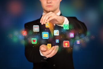 Businessman holding application icons