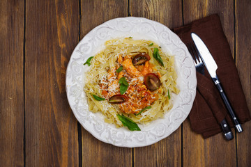 Homemade italian pasta with tomato sauce, chicken, and basil