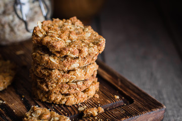 Homemade oatmeal cookies on wooden board on old table background. Healthy Food Snack Concept. COpy space/