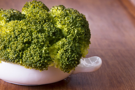 ceramic dish with broccoli on wooden table