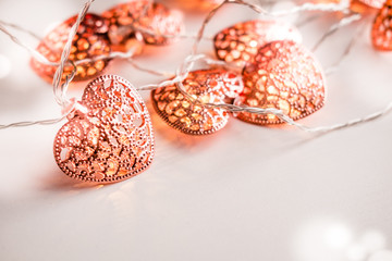 Rose gold colored heart shaped lighting background. Valentine's day, home decor ideas, love emotions concept