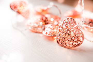 Rose gold colored heart shaped lighting background. Valentine's day, home decor ideas, love emotions concept