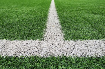 Line on Soccer field or football field texture background. White lines on green grass, symbol to the way to success. Sport and business background concept.