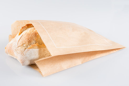 big traditional bread in brown kraft paper wrapper