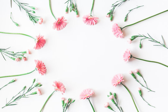 Flowers composition. Frame made of pink flowers on white background. Flat lay, top view, copy space