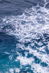 White foam formed by breaking wave in Bali.