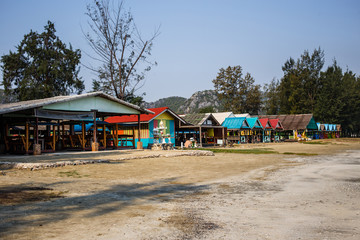shops with bright roofs on the beach