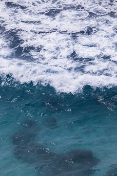 White foam of wave in blue water. © AlexandraDaryl