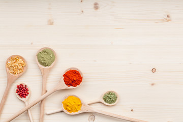 spices and herbs on kitchen wooden table background with copy space for text. food, cooking and restaurant concept. flat lay colorful composition, top view