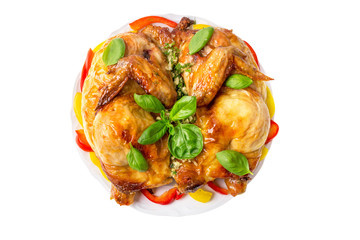 Grilled fried roast chicken tabaka with basil on a plate isolated on white background