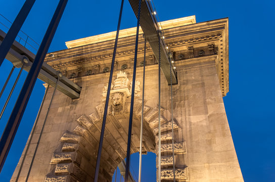 One of two river piers of the Chain Bridge in Budapest at night