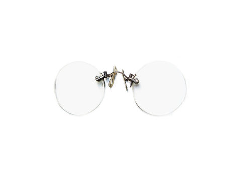 Vintage round pince-nez eyeglasses isolated on white background. Antique reading glasses, rimless eyeglasses
