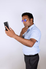 Young man operating smartphone