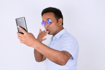 Young man operating smartphone