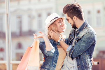 Young couple holding a shopping bags in the city.