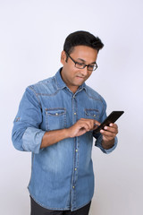 Young man operating smartphone