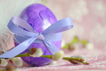 An purple easter egg with branches of willow