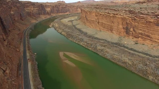 Aerial view flying over the Colorado River through a canyon in Utah near Moab.