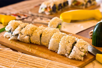 Japanese sushi and rolls with salmon, avocado, cucumber and flying fish caviar
