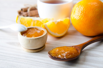 Cup of tea served with orange jam