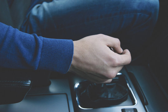 Man's hand on the gear shifter in the sport car 