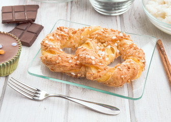 puff pastry tie on modern wood stage with chocolate and cinnamon, in perspective