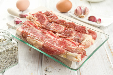 raw churrasco steak ready to be cooked with ingredients, on wooden board