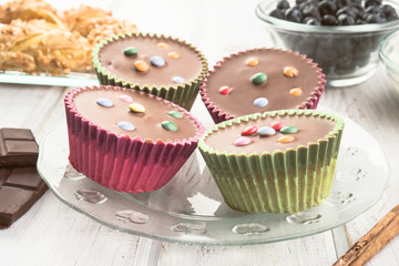 chocolate covered muffins modern wooden stage with chocolate and cinnamon and blueberries