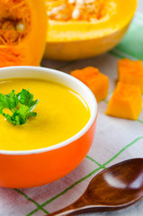 Pumpkin soup served on the table in bowl