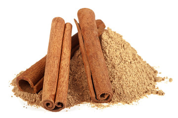 Three cinnamon sticks with powder on a white background