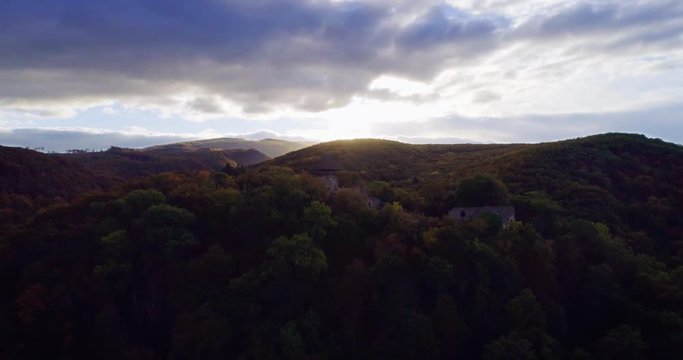 Aerial wiev: Incredible autumn sunrise against the ruins of an ancient castle, autumn paints