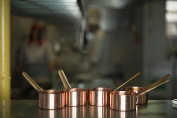 Small copper pots on a restaurant kitchen table