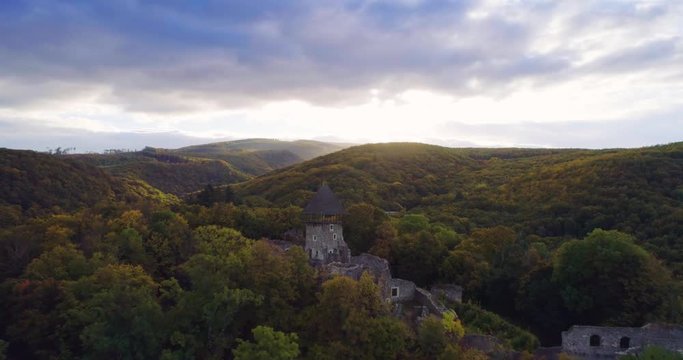 Aerial wiev: Incredible autumn sunrise against the ruins of an ancient castle, autumn paints