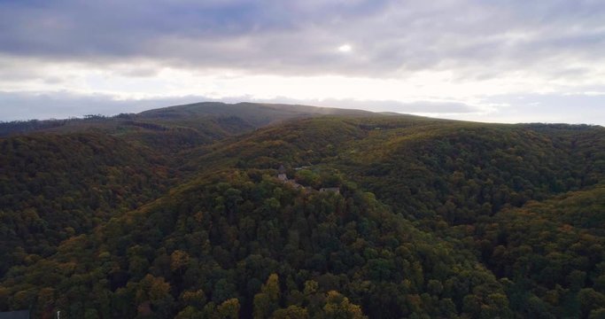 Aerial wiev: Incredible autumn sunrise against the ruins of an ancient castle, autumn paints