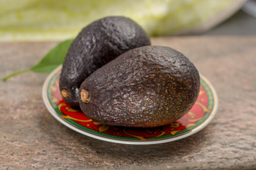 Fresh dark green organic avocado with leaf