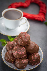 Valentine's Day concept, chocolate profiteroles with pink hearts, stuffed cakes,  special romantic event.