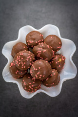 Valentine's Day concept, chocolate profiteroles with pink hearts, stuffed cakes,  special romantic event.