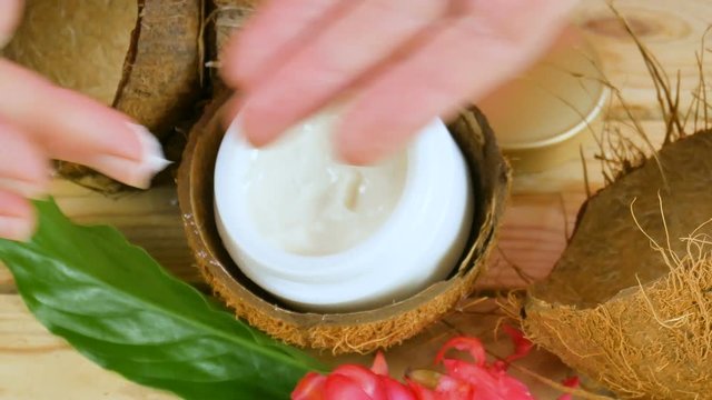 Coconut cosmetic cream with exotic flowers and aloe vera. Hand skin care concept