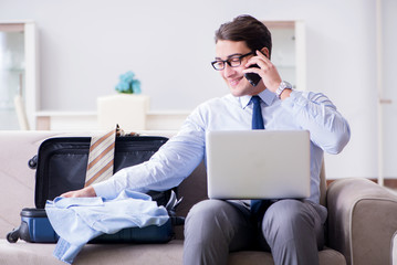 Businessman preparing packing for business trip