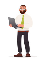 Programmer. A bearded man with glasses is holding a laptop in his hands. Software developer