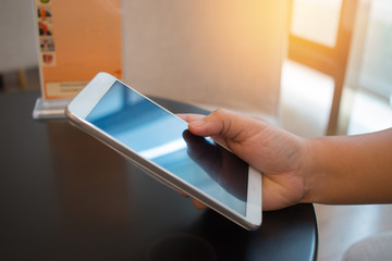 Businesswoman holds Using Online banking payment by network internet wireless development mobile smartphone sync app for Business shopping in coffee shop, Internet concept